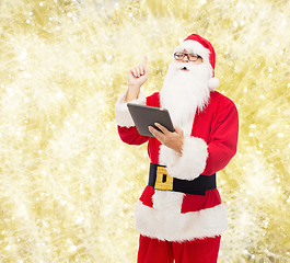 Image showing man in costume of santa claus with tablet pc