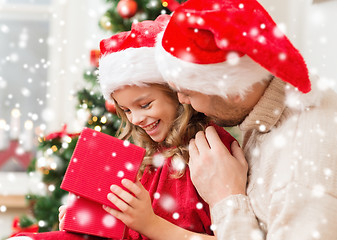 Image showing smiling father and daughter opening gift box