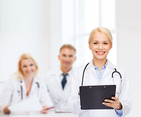 Image showing smiling female doctor with clipboard