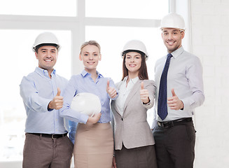 Image showing happy business team in office showing thumbs up