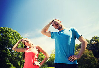 Image showing smiling couple stretching outdoors