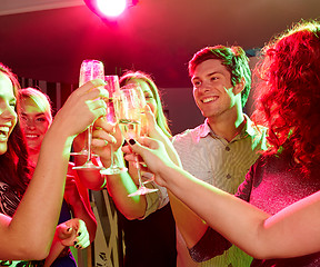 Image showing smiling friends with glasses of champagne in club