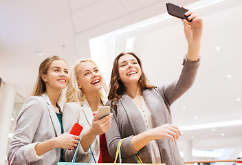 Image showing women with smartphones shopping and taking selfie