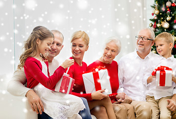 Image showing smiling family with gifts at home