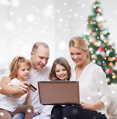 Image showing happy family with laptop and credit card at home