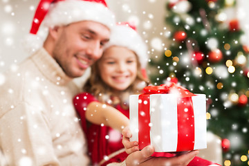 Image showing smiling father and daughter holding gift box