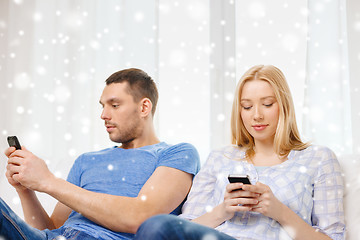 Image showing couple with smartphones at home