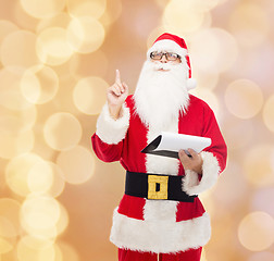 Image showing man in costume of santa claus with notepad