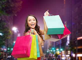 Image showing smiling young woman with shopping bags