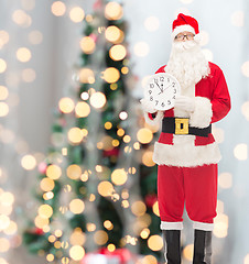 Image showing man in costume of santa claus with clock