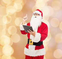 Image showing man in costume of santa claus with tablet pc