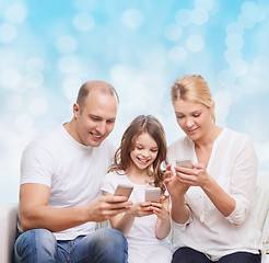 Image showing happy family with smartphones