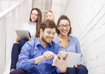 Image showing team with tablet pc computer sitting on staircase