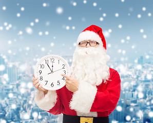 Image showing man in costume of santa claus with clock