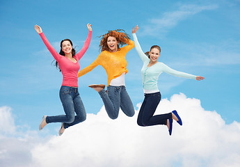 Image showing group of smiling young women jumping in air