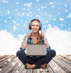 Image showing happy young woman with laptop and headphones