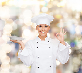 Image showing female chef with plate showing ok sign