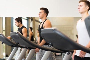 Image showing group of men exercising on treadmill in gym