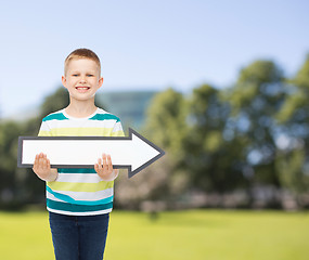 Image showing smiling little boy with blank arrow pointing right