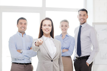Image showing businesswoman in office pointing finger at you