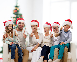 Image showing happy family sitting on couch at home