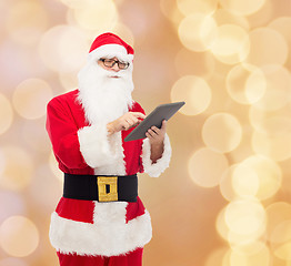 Image showing man in costume of santa claus with tablet pc