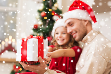 Image showing smiling father and daughter holding gift box