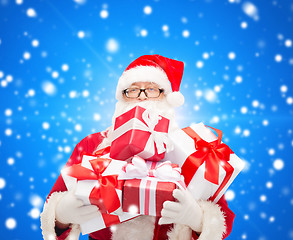 Image showing man in costume of santa claus with gift boxes