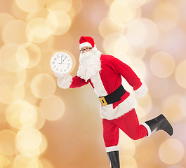 Image showing man in costume of santa claus with clock