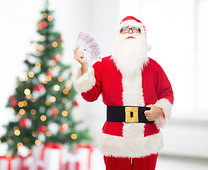 Image showing man in costume of santa claus with euro money