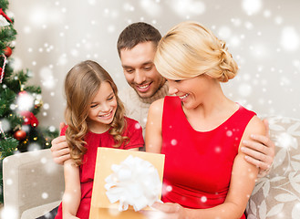 Image showing smiling family looking into open gift box