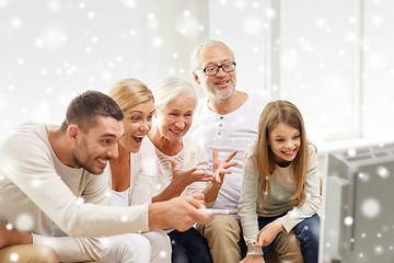 Image showing happy family watching tv at home