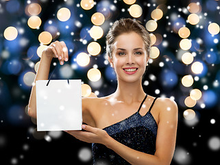 Image showing smiling woman with white blank shopping bag