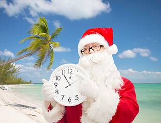 Image showing man in costume of santa claus with clock