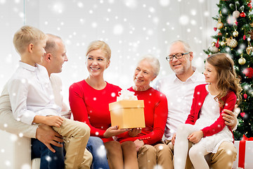 Image showing smiling family with gift at home