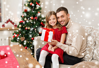 Image showing smiling father and daughter holding gift box