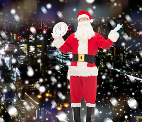 Image showing man in costume of santa claus with clock