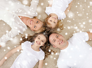 Image showing parents and two girls lying on floor at home