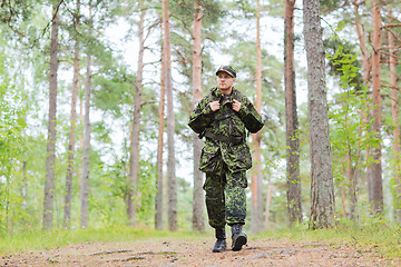 Image showing young soldier with backpack in forest