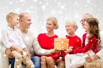 Image showing smiling family with gift at home