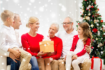 Image showing smiling family with gifts at home