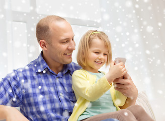Image showing happy father and daughter with smartphone