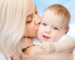 Image showing happy mother kissing smiling baby