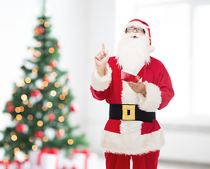 Image showing man in costume of santa claus with notepad