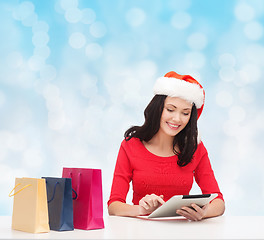 Image showing smiling woman with shopping bags and tablet pc