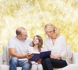 Image showing happy family with book at home