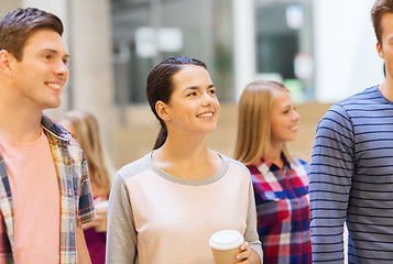 Image showing group of smiling students with paper coffee cups