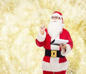 Image showing man in costume of santa claus with notepad