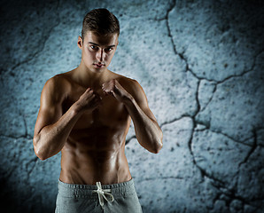 Image showing young man in fighting or boxing position