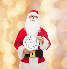 Image showing man in costume of santa claus with clock